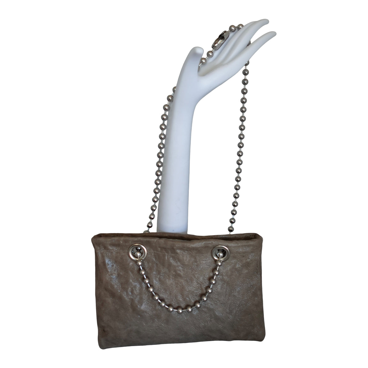 a hand holding a purse