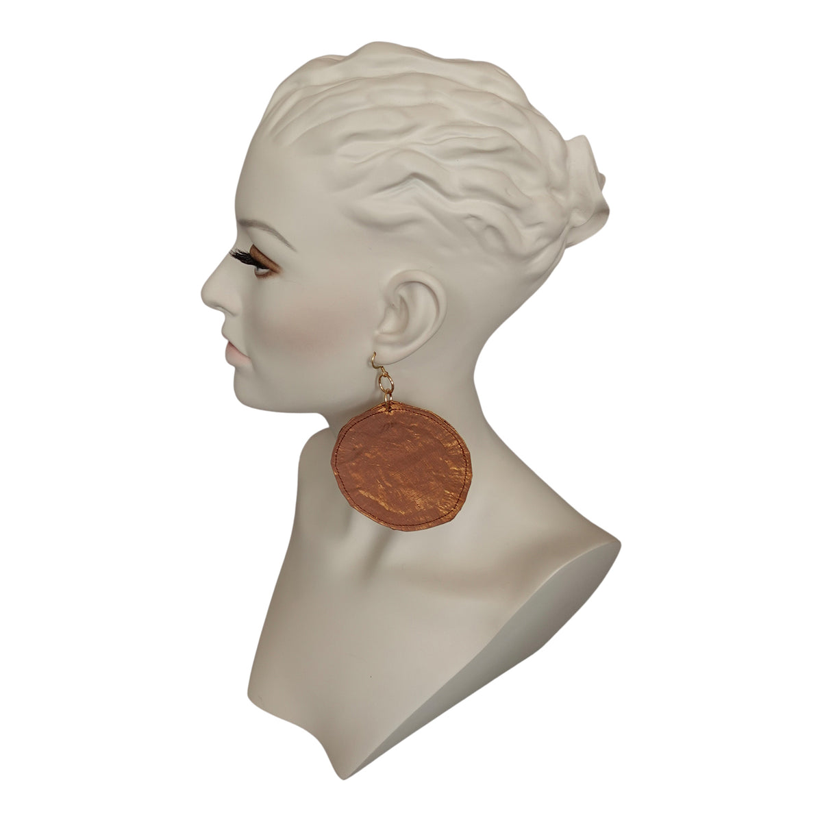 a mannequin head with a large earring