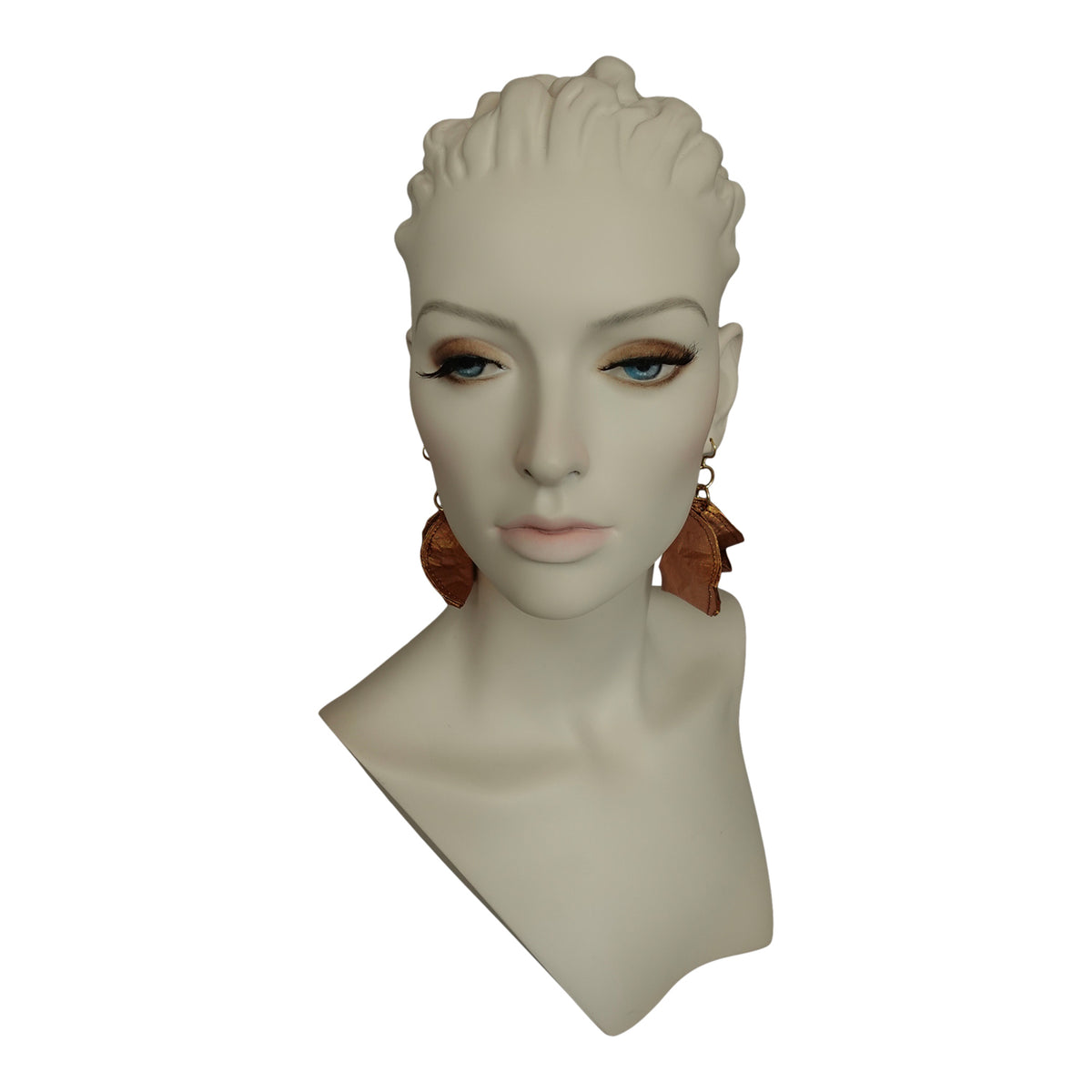 a mannequin head with earrings