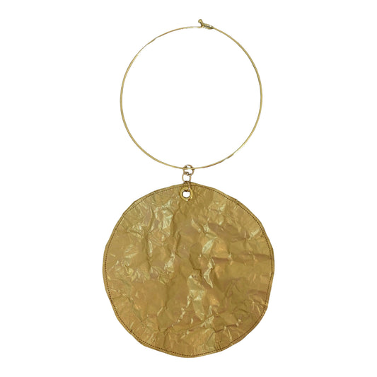 a gold circle necklace with a chain