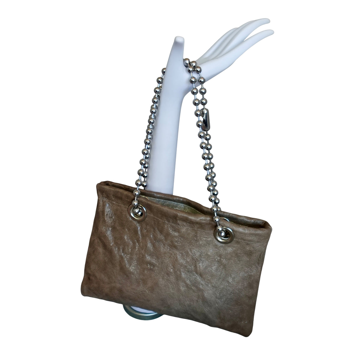 a hand holding a purse