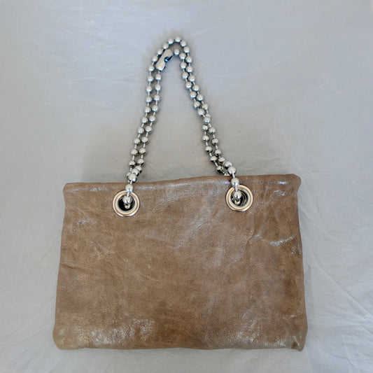 a brown bag with silver chain