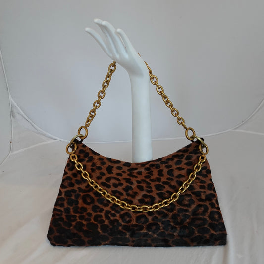 a hand holding a purse