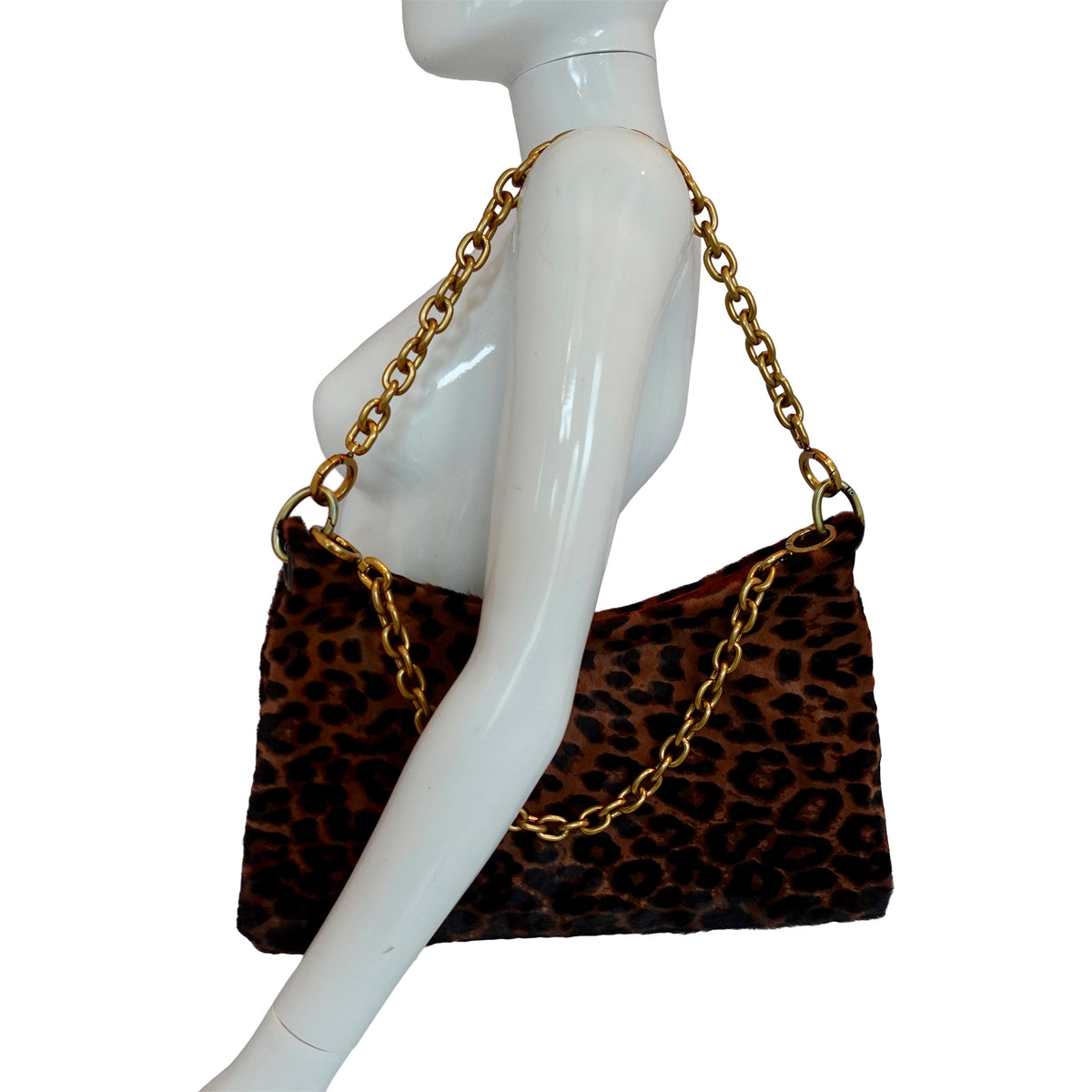 a mannequin with a leopard print purse