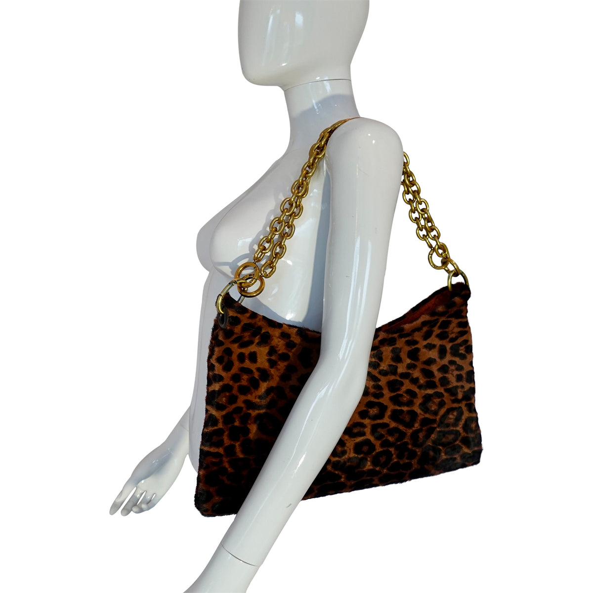 a mannequin with a leopard print purse