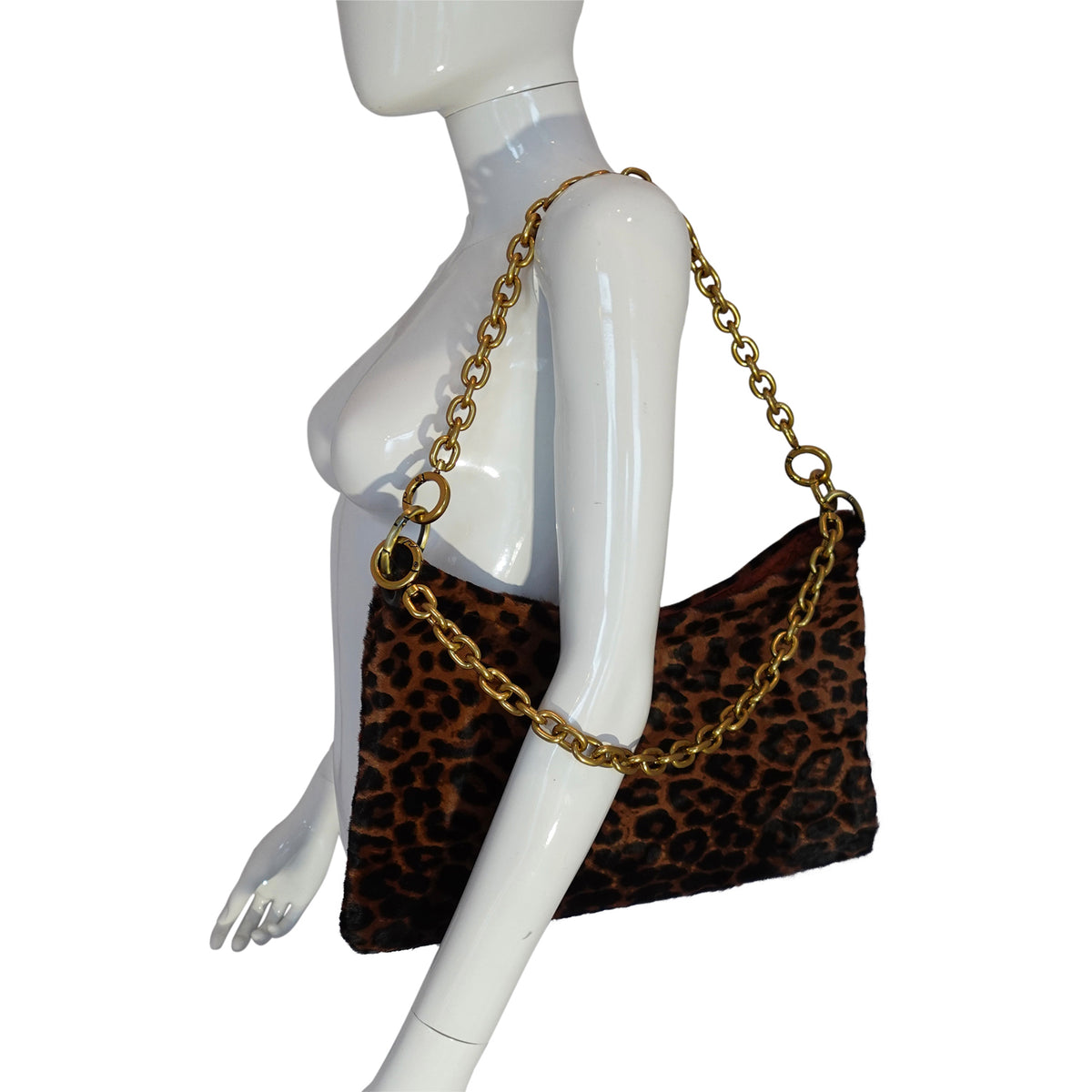 a mannequin with a leopard print purse